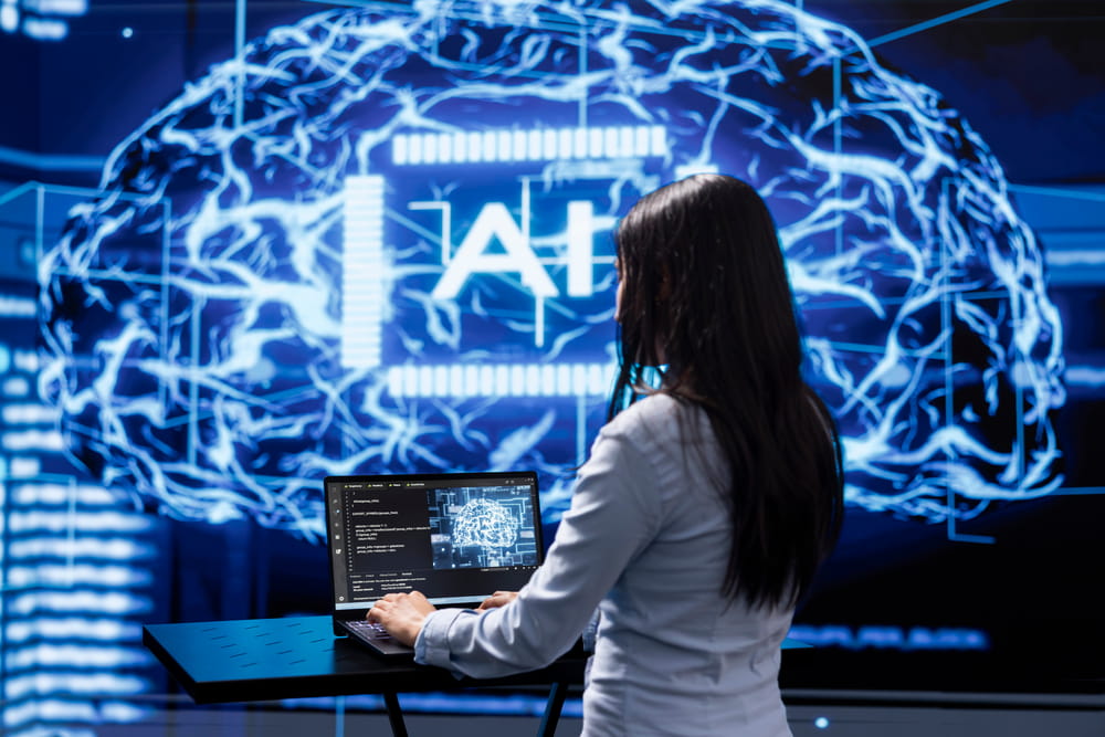 Programmer building AI models on a laptop, illustrating how AI talent providers support enterprise AI implementation